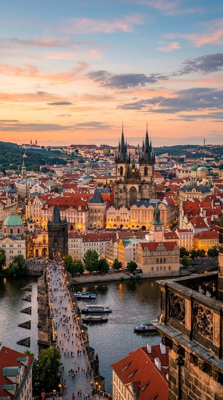 Prague, Czech Republic cityscape at sunset with the historic Charles Bridge, Vltava River, and Church of Our Lady before Týn.